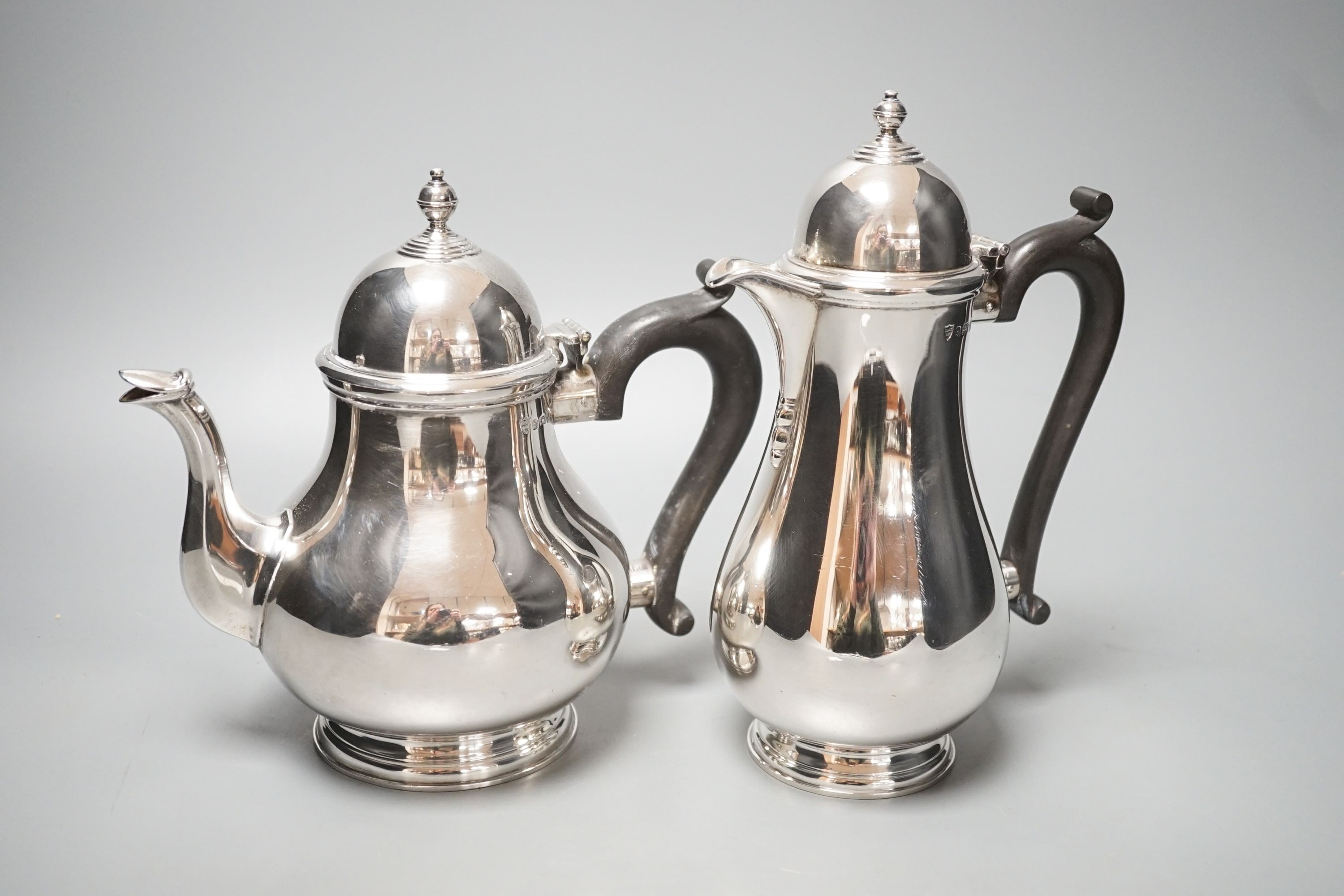 A 1930's silver coffee pot and a similar silver how water pot, Birmingham, 1934 & 1935, gross 39oz.